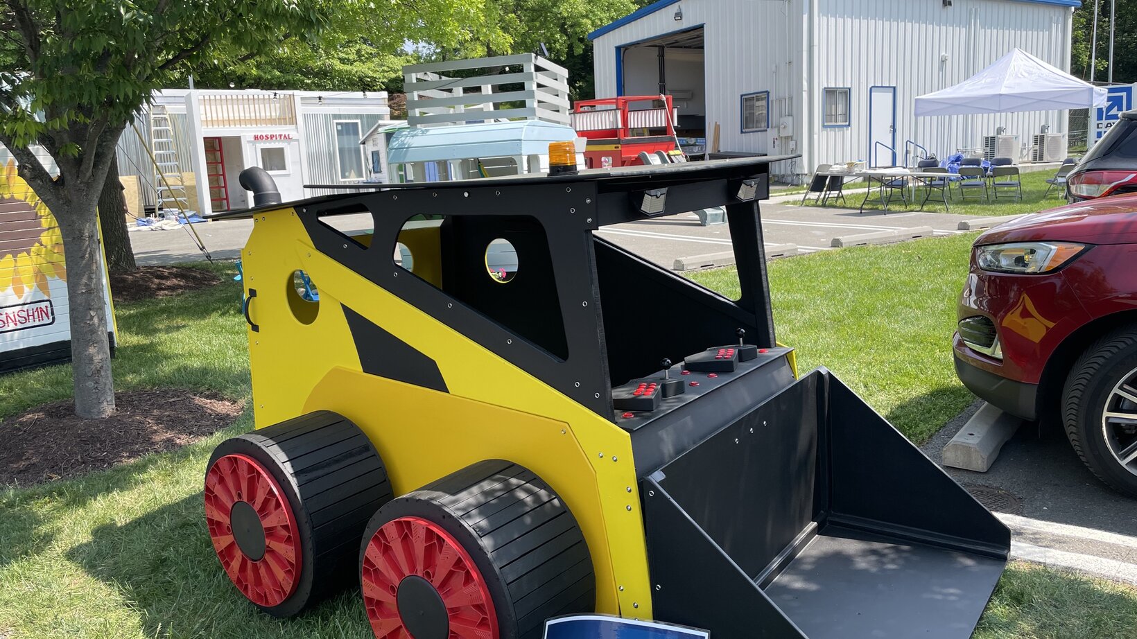 A miniature version of a Bobcat Skid Steer vehicle with a front end loader