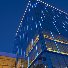 building with vertical blue lights at night