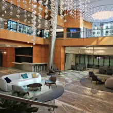Renovation of a lobby featuring light fixtures hanging from the ceiling.