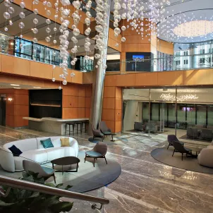 Renovation of a lobby featuring light fixtures hanging from the ceiling.