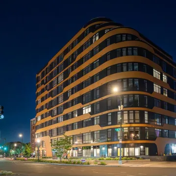 Exterior shot of an apartment building at night.