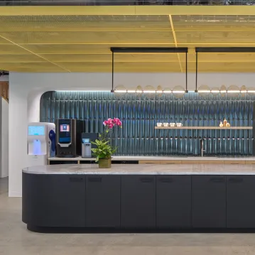 An office kitchen with beverage machiens, light fixtures and other items
