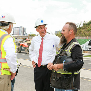 Jim Davis conversing with construction worker