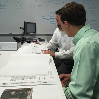 two workers reviewing drawings 