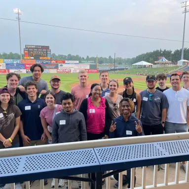 Group of interns together at a baseball game