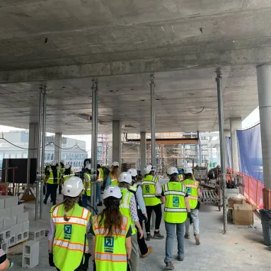 Group of interns walk together in construction gear