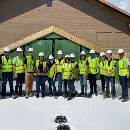 Project team poses for a photo at the topping out celebration