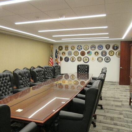 Conferencing room with a large rectangular table and chairs