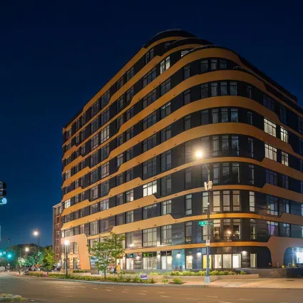 Exterior shot of an apartment building at night.