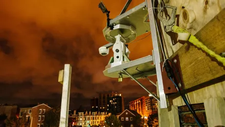 Robotic camera affixed to building under construction