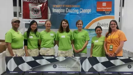 group of women in green shirts looking at camera