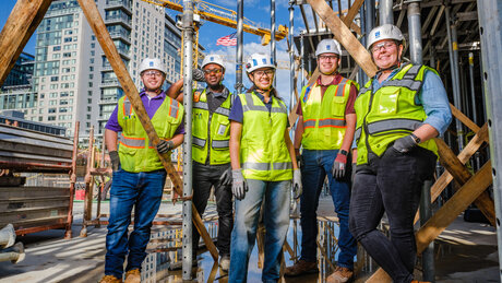 DAVIS team poses for the camera at a construction site.