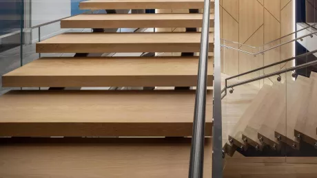 A wooden staircase with metal handrails