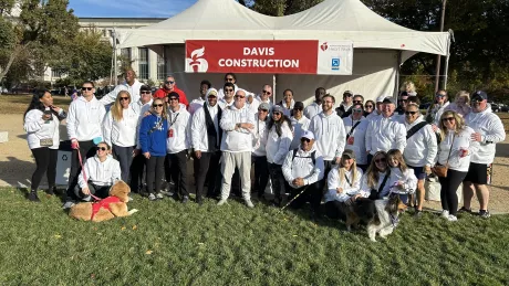 Group photo of walking team wearing matching white sweaters w