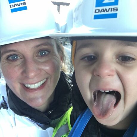 mother with her young son wearing construction helmets