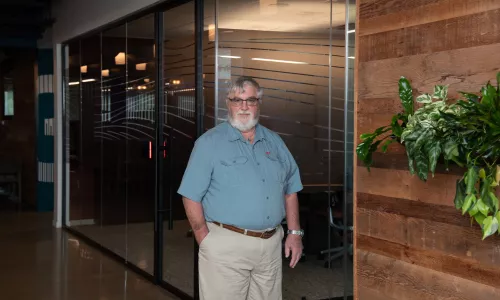Man standing in office hallway