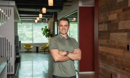 Man in professional wear standing in office hallway