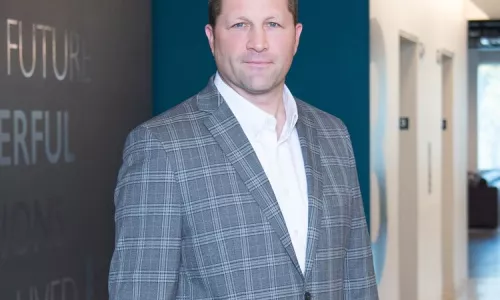 Man in professional wear standing in office hallway