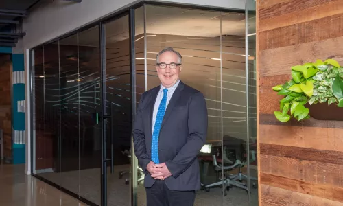 Man in professional wear standing in office hallway