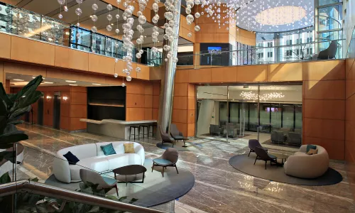 Renovation of a lobby featuring light fixtures hanging from the ceiling.