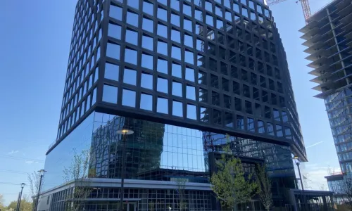 Exterior shot of an apartment building in the day.