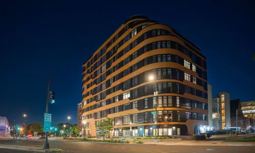 Exterior shot of an apartment building at night.