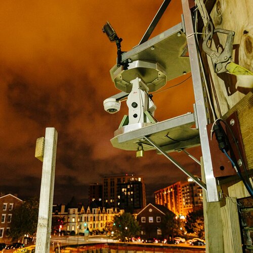 Robotic camera affixed to building under construction