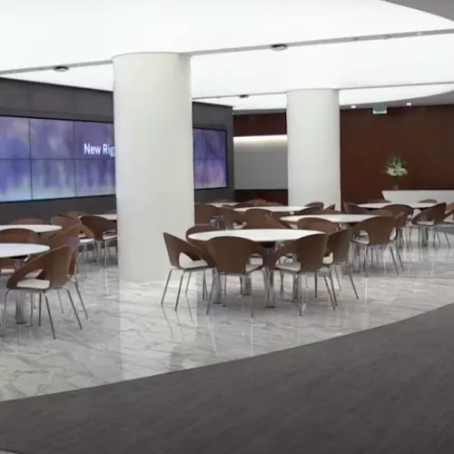 view of meeting area with wall of screens in background