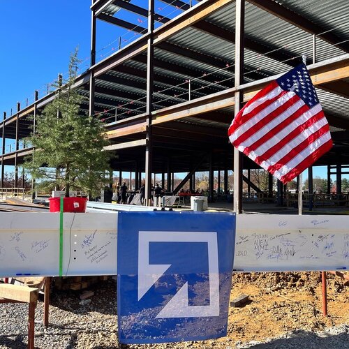 Construction beam with DAVIS logo, a tree, and an American flag