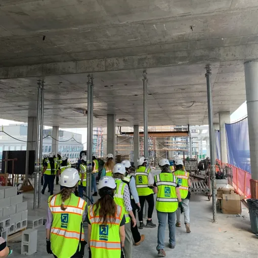 Group of interns walk together in construction gear