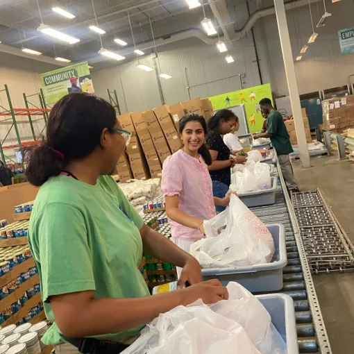 Two interns in a food bank interacting