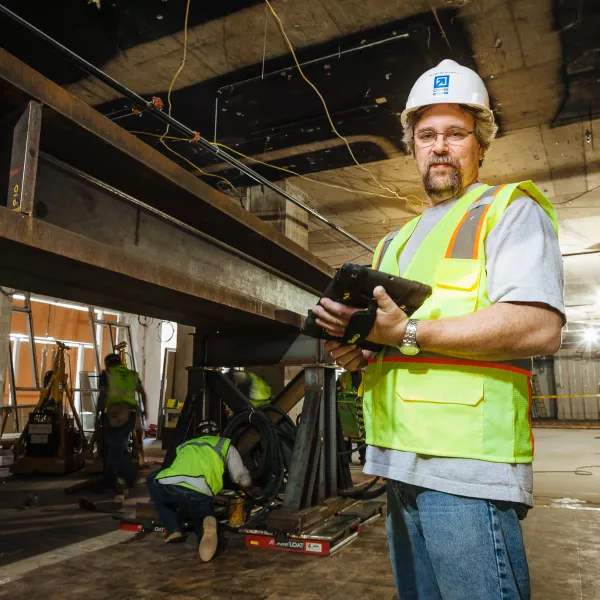 worker in construction safety gear looking at camera