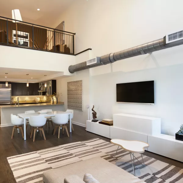 sitting area and kitchen with staircase to the left