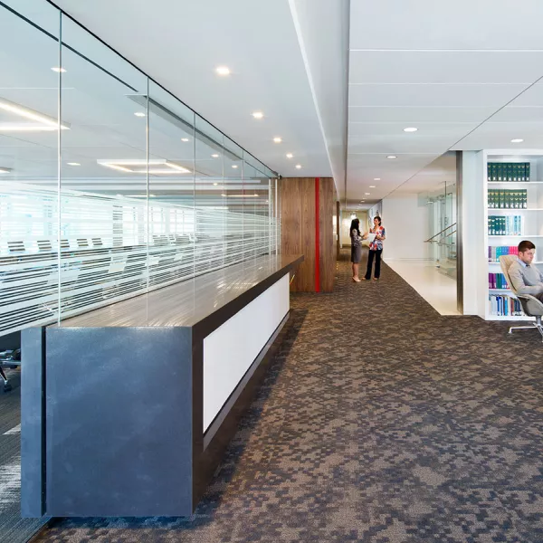 hallway with conference room on left and sitting area on right