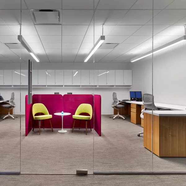 small meeting area surrounded by workstations