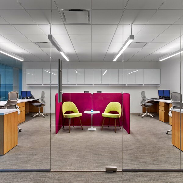 small meeting area surrounded by workstations