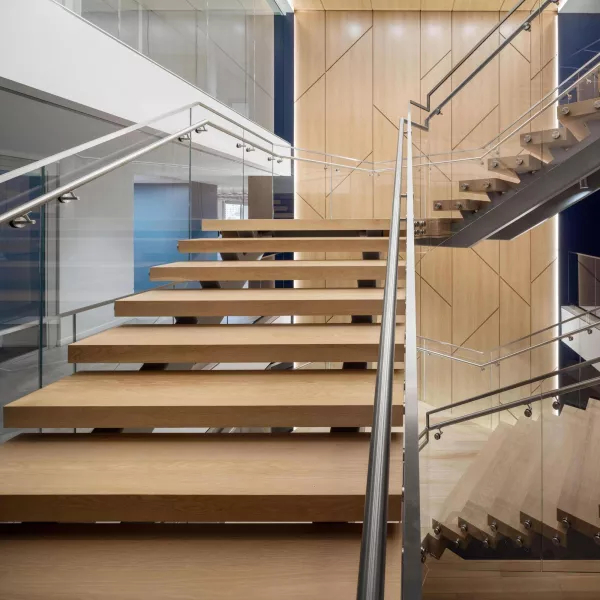 A wooden staircase with metal handrails
