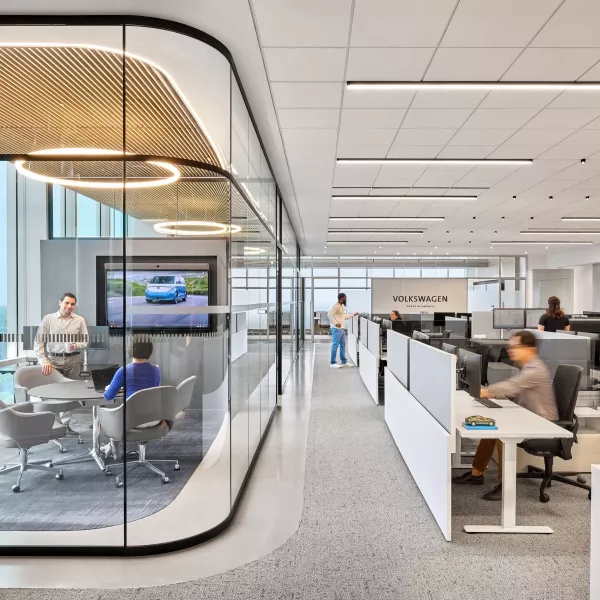 Office workers sitting at their desk and in a conference room.