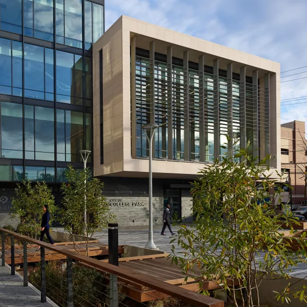 Exterior shot of a building with rainwater treatment structure in the foreground.