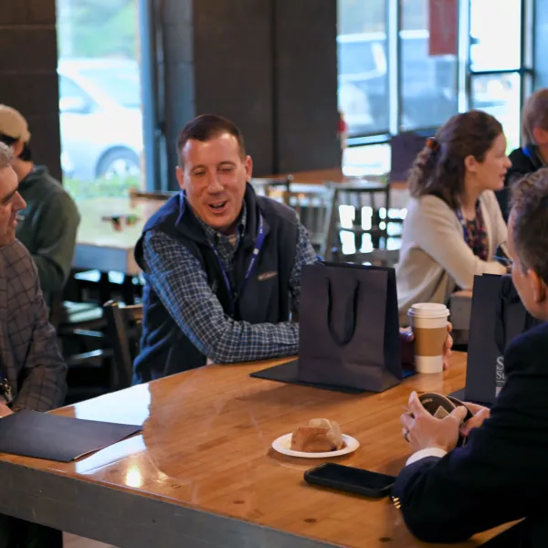 People sit at a table and discuss