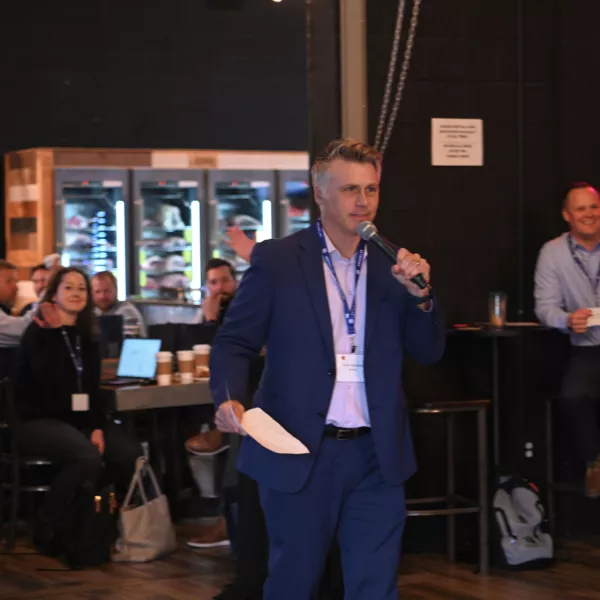 A man holds a mic in front of other people