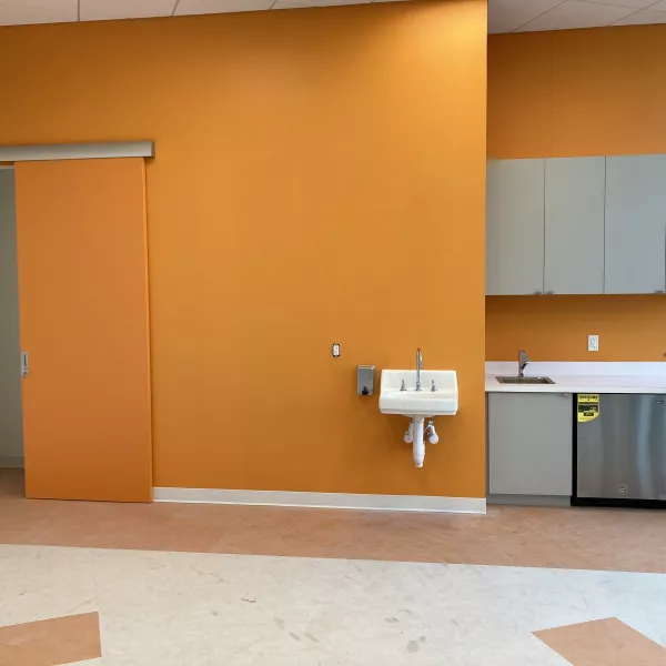 room in a daycare center with an orange wall