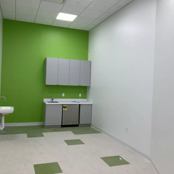 room in a daycare center with a green wall