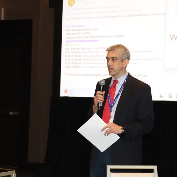 Dominic Argentieri speaking on stage