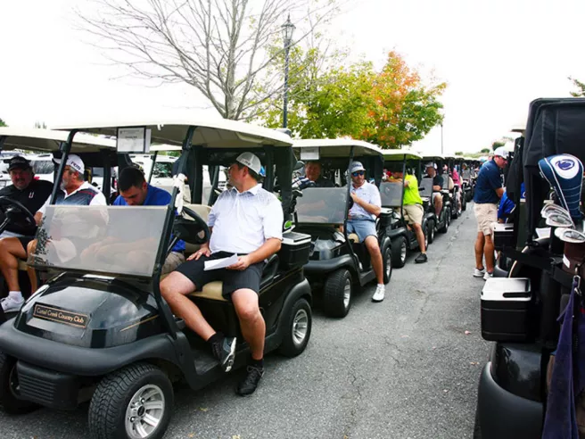 individuals in parked golf carts 