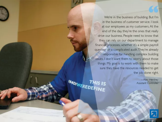 man at computer with quote