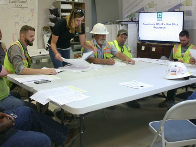 workers around a table planning