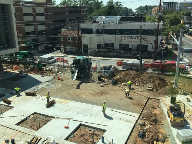 view of construction work on the public plaza in front of city hall.