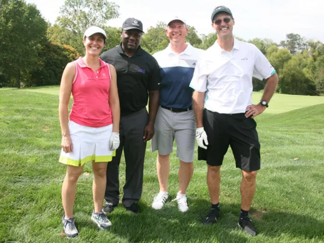 four people at golf tournament