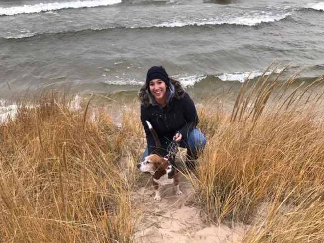 Young person on beach with dog